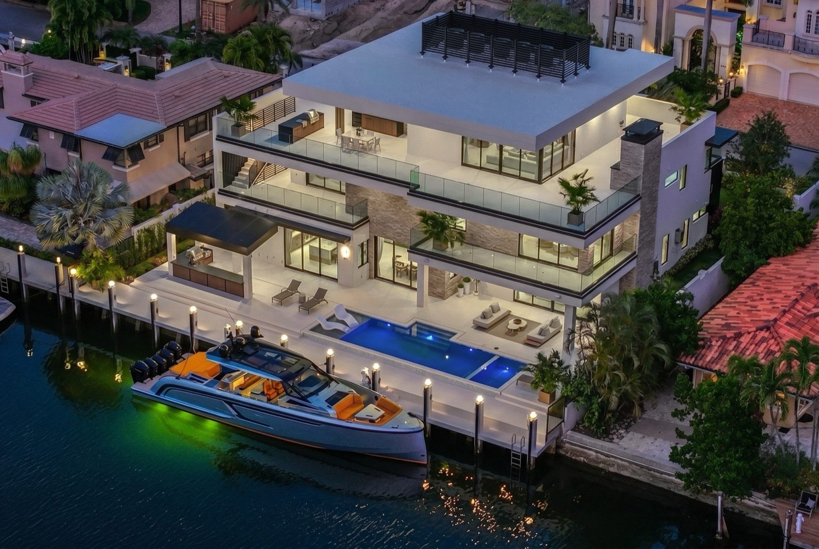 Aerial view of a Calderco residence, rooftop terrace, pool, and dock